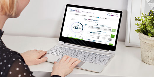 A woman looking at the credit page on her laptop.