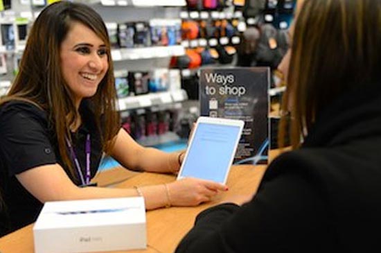 Currys expert discussing a tablet with a customer.