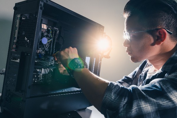 A man installing hardware into his PC